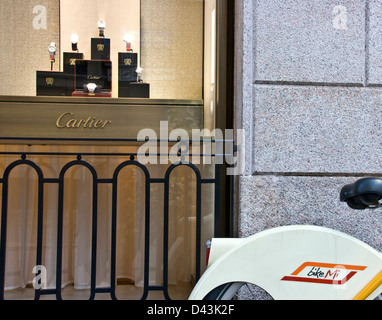 Bike Mi rental bike outside Cartier luxury designer watch store Milan Lombardy Italy Europe Stock Photo