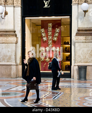 Chic stylish smart elegant women passing a Louis Vuitton designer boutique in Galleria Vittorio Emanuele II Milan Lombardy Italy Stock Photo