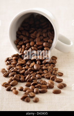 Close-up of Coffee Beans Spilling out of Mug Stock Photo