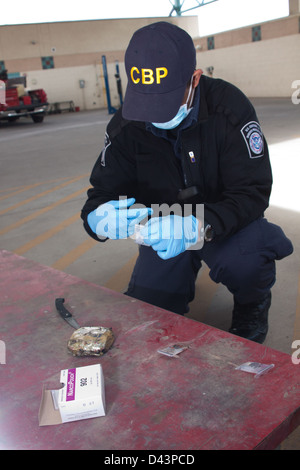 U.S. Customs & Border Protection Officer Testing Heroin that was Found Concealed in a Vehicle Stock Photo