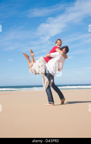 Playful Mature Couple on the Beach, Camaret-sur-Mer, Crozon Peninsula, Finistere, Brittany, France Stock Photo