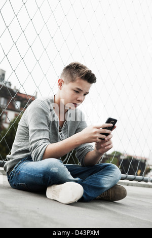 Teenage Boy Using Cellular Telephone, Mannheim, Baden-Wurttemberg, Germany Stock Photo