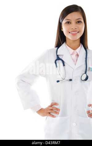 Attractive Southeast Asian female medical doctor standing isolated on white background. Stock Photo
