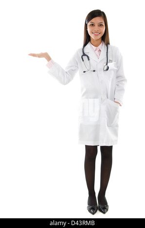 Attractive Southeast Asian female medical doctor standing isolated on white background. Stock Photo