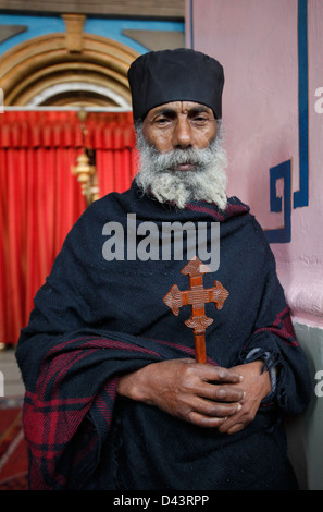 Ethiopian orthodox monk inside the Ethiopian Church of Kidane Mehret situated within the compound of the Debre Genet monastery (Sanctuary of Paradise) located in Ethiopia Street West Jerusalem Israel Stock Photo