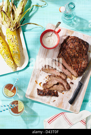 Flank Steak, Corn on the Cob and Glasses of Iced Tea Stock Photo