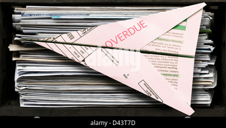 Stack of Unopened Bills with one Folded into Paper Airplane Stock Photo