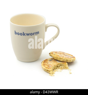 White mug with two biscuits cut out white background Stock Photo