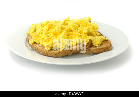 Scrambled eggs on two pieces of toast cut out white background Stock Photo