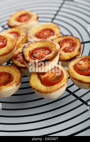 Mini quiches with tomato, cheese and smoked ham Stock Photo