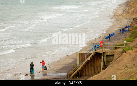 Surfers on beach at Compton Bay, Isle of Wight, UK. Stock Photo