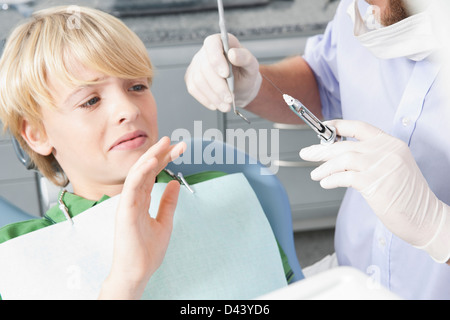 Boy declining Needle at Dentist's Office during Appointment, Germany Stock Photo