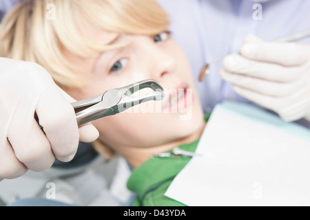 Anxious Boy looking at Dental Instruments during Appointment, Germany Stock Photo