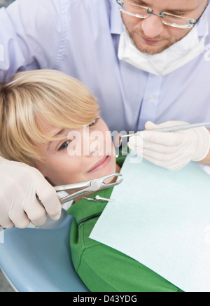 Anxious Boy looking at Dental Instruments during Appointment, Germany Stock Photo