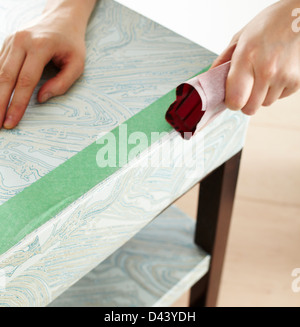 Close-up of Woman's Hands Sanding Table in Studio Stock Photo