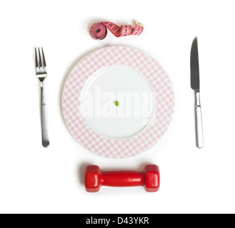 Plate with one peas. Dumbbell and centimeter measure. Studio shot Stock Photo