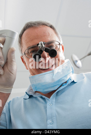 Close-up of Dentist with Magnifier on Eyeglasses in Dental Office, Germany Stock Photo