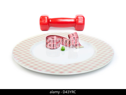 Plate with one peas. Dumbbell and centimeter measure. Studio shot Stock Photo