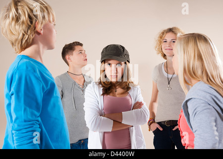 Portrait of Teenage Girl wearing Baseball Hat Looking at Camera, Standing in the Middle of Group of Teenage Boys and Grils