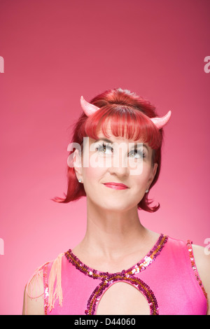 Portrait of Woman Wearing Devil Horns Stock Photo