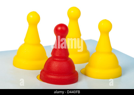 Red and yellow game pawns white isolated. Lideship conception Stock Photo