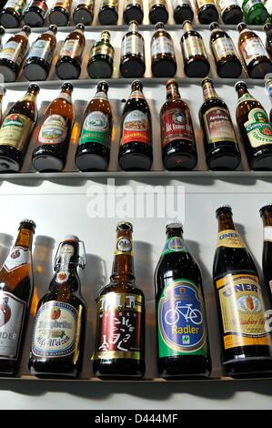 Beer bottles of different types are pictued in a shelf at the International Green Week in Berlin, Germany, 29 January 2012. Fotoarchiv für ZeitgeschichteS.Steinach Stock Photo