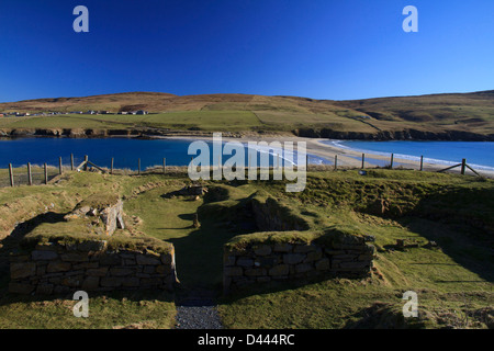 The ancient chapel on St Ninian's Isle, Shetland, with the tombolo connecting the island to the mainland in the background Stock Photo