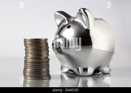 pig bank and stack of coins isolated on white background Stock Photo