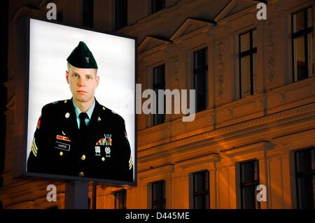 Portrait of a young American soldier at the former border post Checkpoint Charlie in Berlin, Germany, 8 March 2011. On the back of the illuminated image, there is a portrait of a young Soviet soldier. The installation of photographer Frank Thiel from 1994 indicated the former inner-German border between the American and Soviet sector of the city. Fotoarchiv für ZeitgeschichteS.Steinach Stock Photo