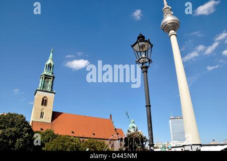 View of St. Mary's Church and TV Tower at Alexanderplatz in Berlin, Germany, 22 August 2011. In the background, the tallest building of Berlin, the Park Inn by Radisson Hotel, is pictured which also serves as an observation platform for tourists. In the foreground, parts of the Neptune Fountain and a typical gas lighting of the late 19th century an be seen. Fotoarchiv für ZeitgeschichteS.Steinach Stock Photo
