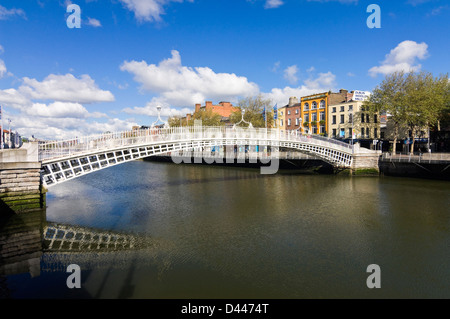 Horizontal view of the Ha'Penny Bridge aka Droichead na Leathphingine or Liffey bridge in Dublin on a sunny day. Stock Photo