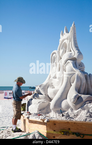 A professional sand sculptor works on the beach during a competition in Siesta Key, FL. Stock Photo