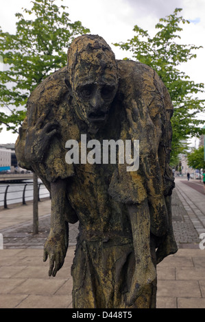 Vertical close up of one of the statues consisting the Famine Memorial on the quayside in Dublin. Stock Photo