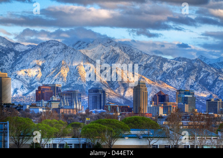 Panoramic view of the downtown Salt Lake City skyline in early spring with the snow capped Wasatch Mountains in the background Stock Photo