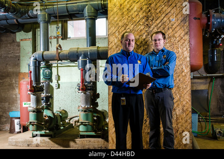 Maintenance engineers check out boiler operations. Stock Photo