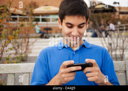 Middle Eastern student using cell phone Stock Photo