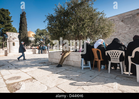 Temple mount, Jerusalem, Israel. Muslim women and a Female israeli soldier near the Al-Aqsa Mosque. Golden Dome in Background. Stock Photo