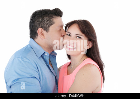 Close-up portrait of woman being affectionately kissed by her husband Stock Photo