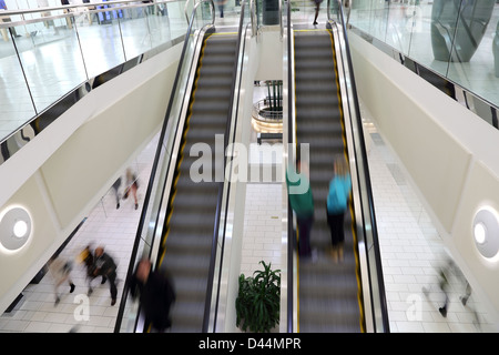 People in motion in escalator Stock Photo
