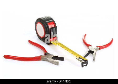 two different red pliers and measuring tape isolated on white Stock Photo