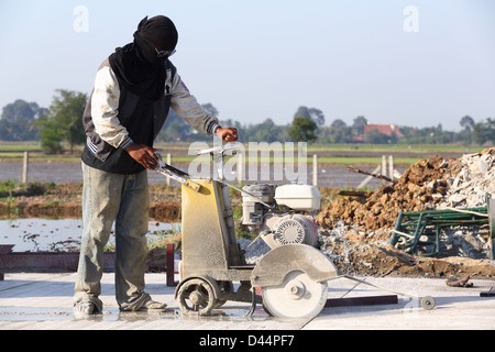 Concrete Joint cutting on new road surface Stock Photo