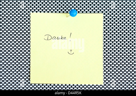 Postit note saying Danke arranged on black and white background Stock Photo