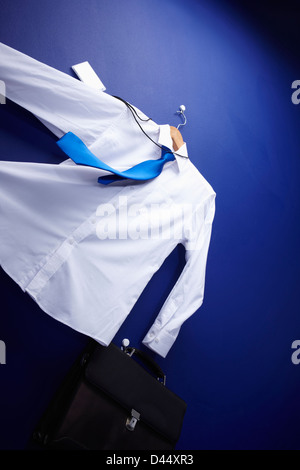 a shirt holding a bag hanging on a hanger blowing Stock Photo