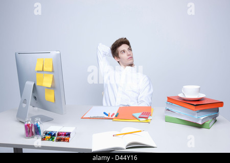 a man having a rest on a desk Stock Photo