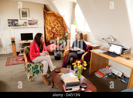 Two Cambridge University women students having coffee in their room, Clare College Cambridge UK Stock Photo