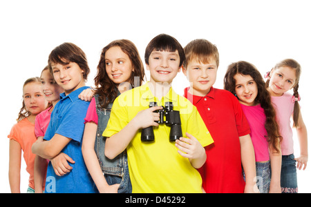 Big group of kids with happy boy holding binoculars Stock Photo