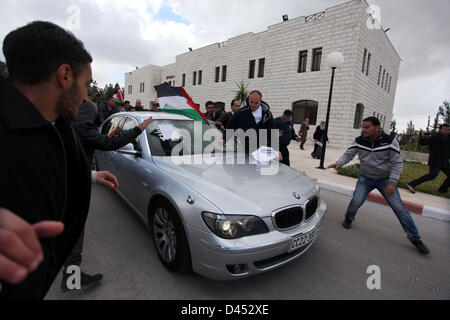 March 5, 2013 - Ramallah, West Bank, Palestinian Territory - Palestinian students from Birzeit University attack the vehicle of Vincent Finn, British Consul General in Jerusalem, after he was forced to leave Birzeit University Campus in the West Bank city of Ramallah on March 5, 2013. Dozens of Angry Students Protest Against Fean' Visit, Pushed him to his car and kicks his car by their hands and legs after being forced to cancel a lecture in the Campus, the Protest Against British silence from Palestinian prisoners hunger strike and their public support to Israel, Protesters Said  (Credit Imag Stock Photo