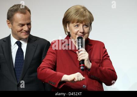 German Chancellor Angela Merkel and Prime Minister of Poland, Donald Tusk (L) visit the booth of SAP during the opening round tour of the world's largest computer expo CeBIT in Hanover, Germany, 05 March 2013. Photo: FRISO GENTSCH Stock Photo