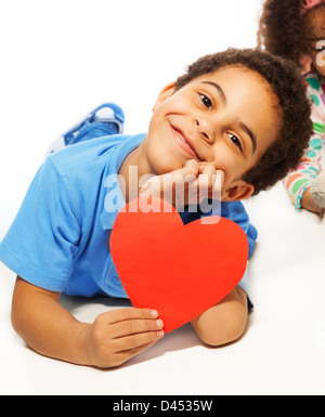 Cute five years old boy with heart symbol with big smile, isolated on white Stock Photo