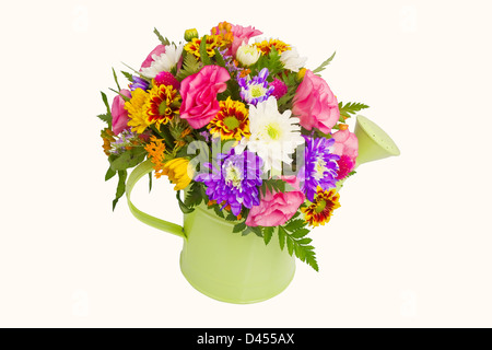 Colorful bunch of spring flowers in watering pot isolated over white background Stock Photo